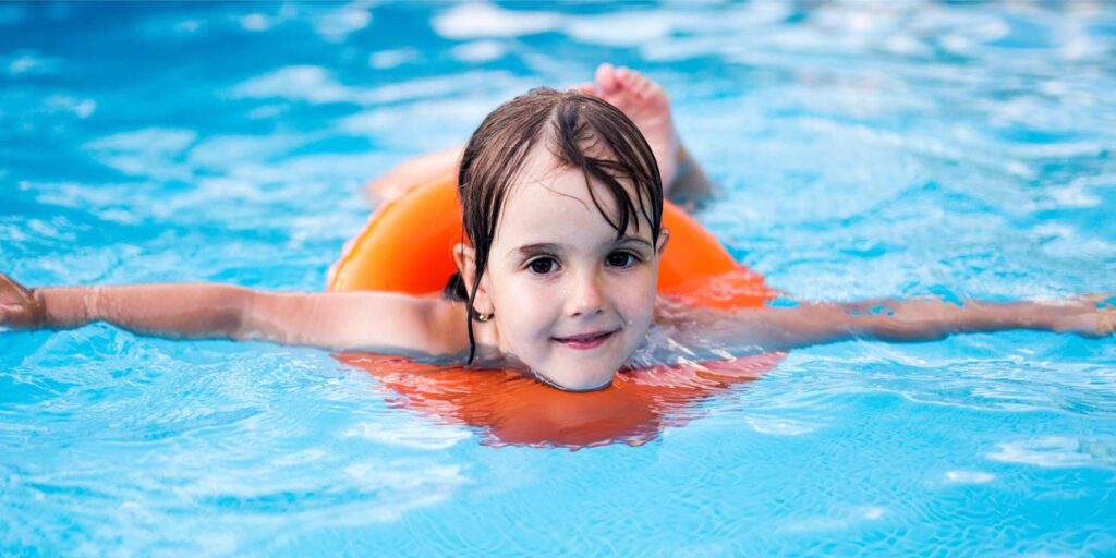 Girl Swimming in Swimming Pool